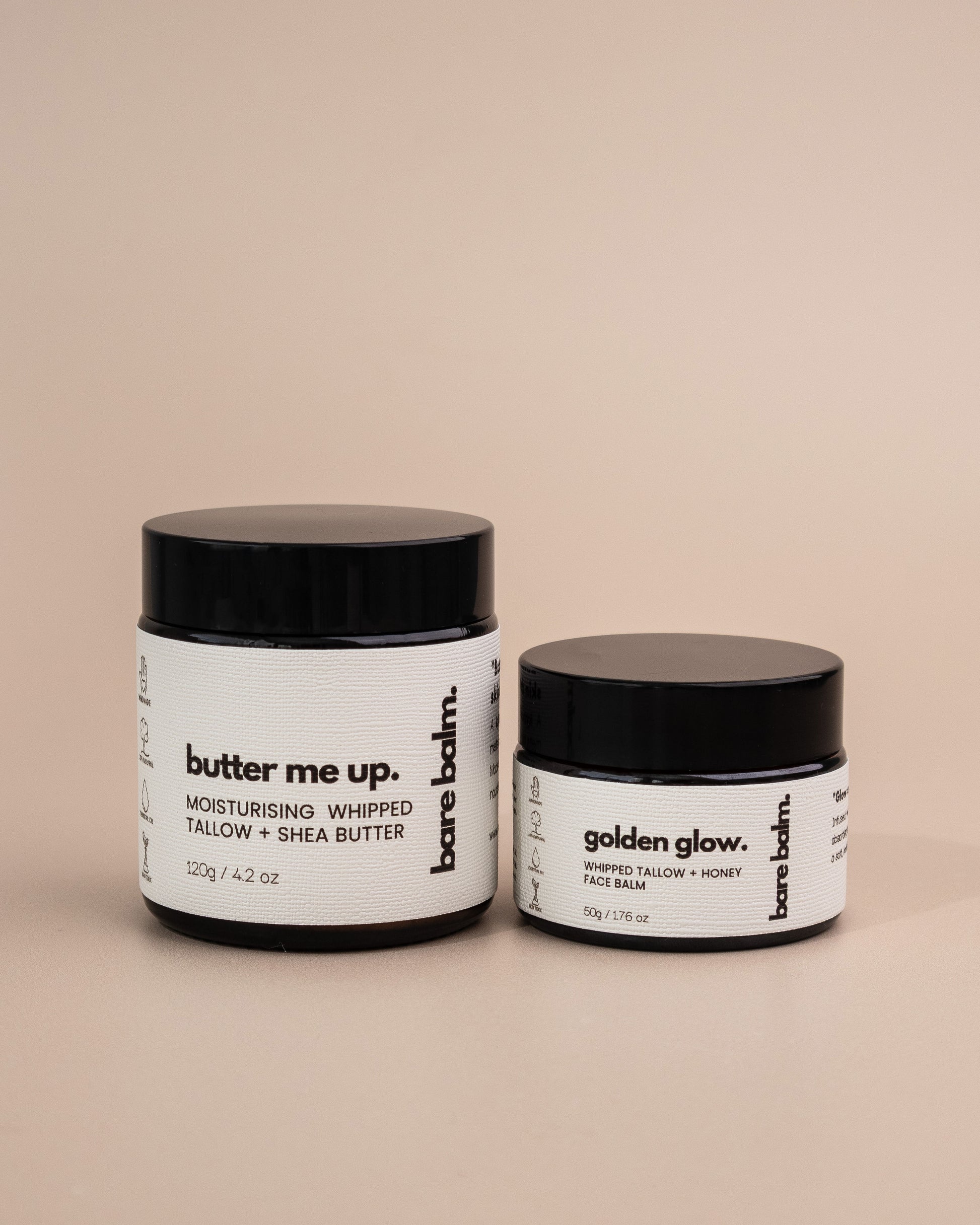 Two jars of barebalm skincare products on a beige background - Golden Glow tallow skincare balm texture – grass-fed tallow with lavender and frankincense