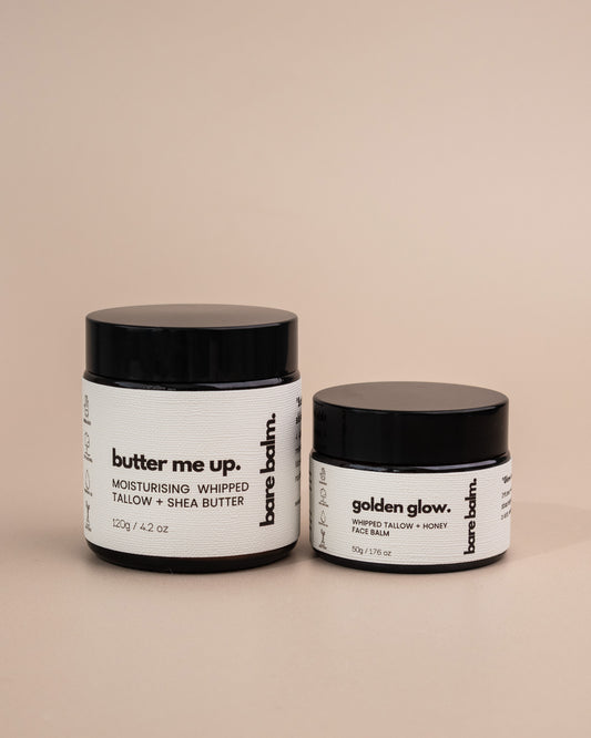 Two jars of barebalm skincare products on a beige background - Golden Glow tallow skincare balm texture – grass-fed tallow with lavender and frankincense
