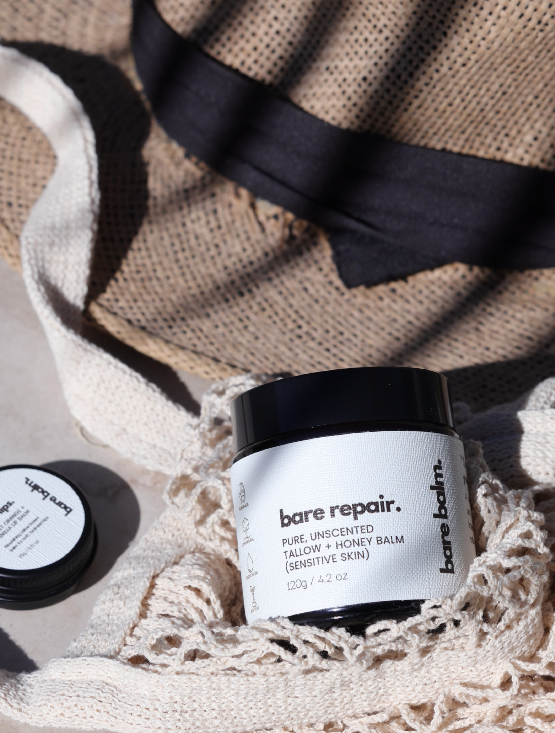 bare repair tallow skincare on flatlay beach